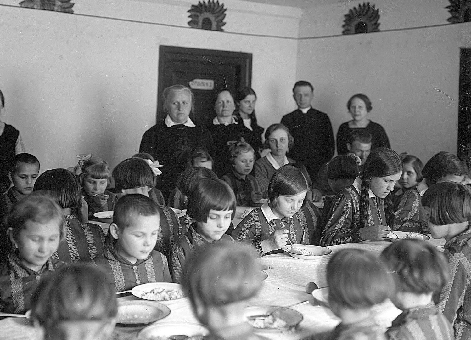 Fotografia z grupą dzieci jedzących obiad przy stole