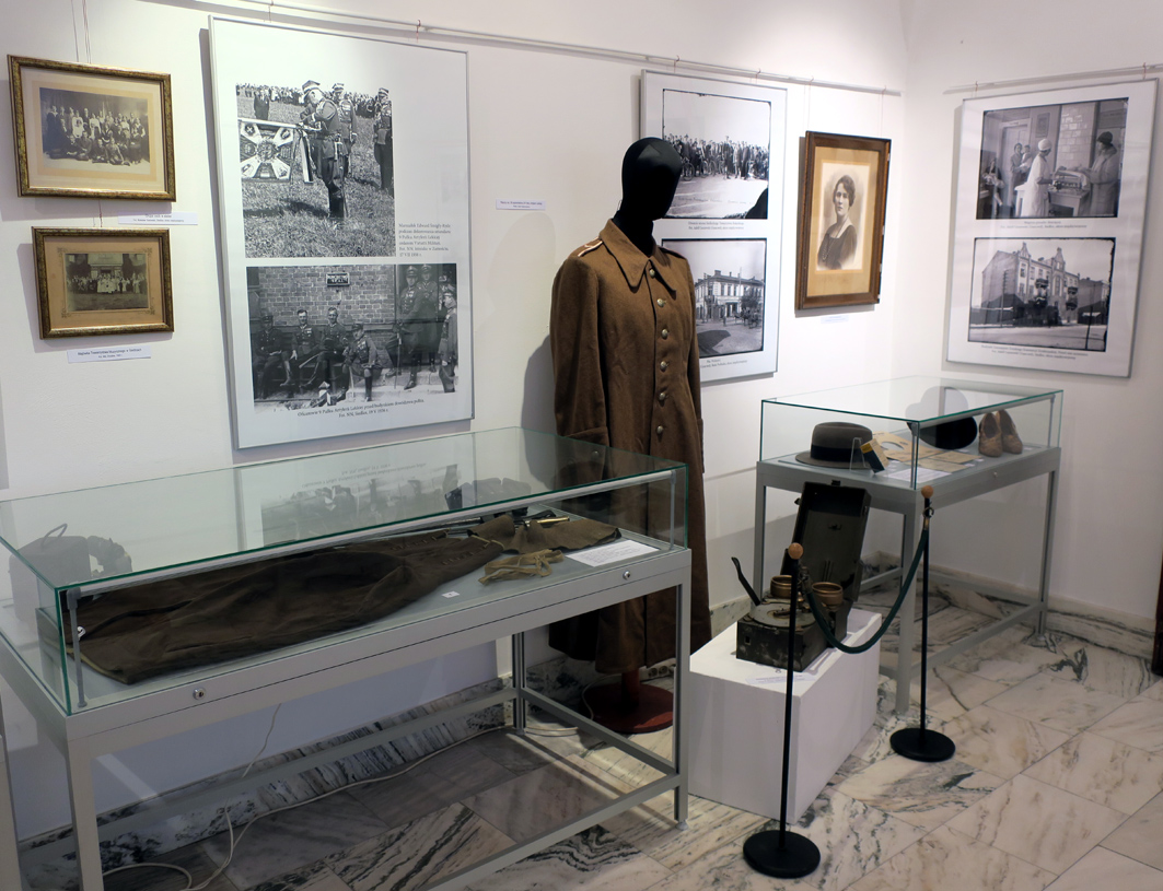 Fragment wystawy z prezntowanymi archiwalnymi fotografiami różnych postaci, polskim mundurem na manekinie oraz różnymi przedmiotami w gablotach 