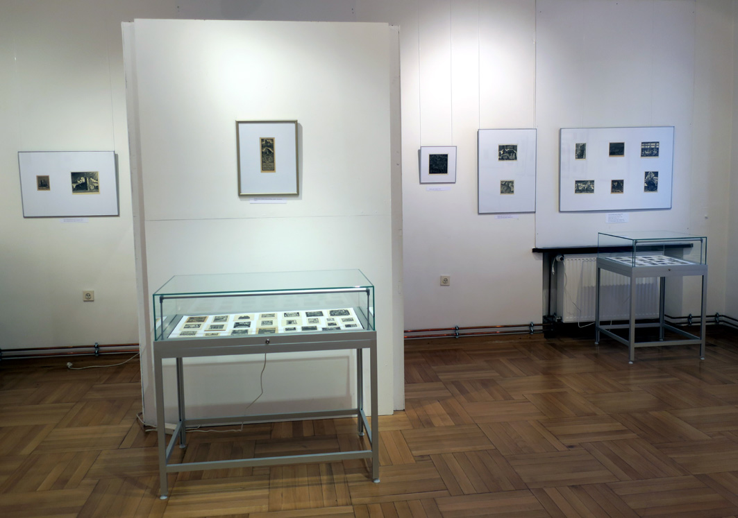 Fragment wystawy z grafikami artysty prezentowanych w fotoramach i gaplotach ekspozycyjnych z różnymi motywami